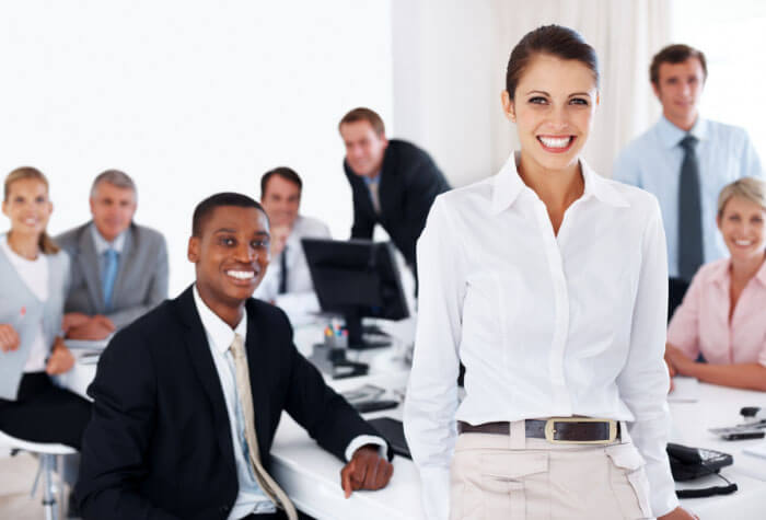 Image of professionals in a business meeting about continuing education, smiling.