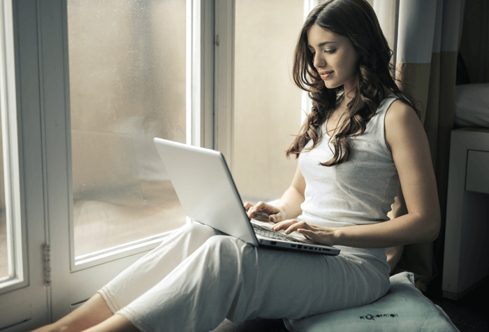 Girl taking online classes on her laptop.