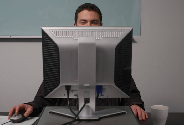 Man sitting behind desktop computer