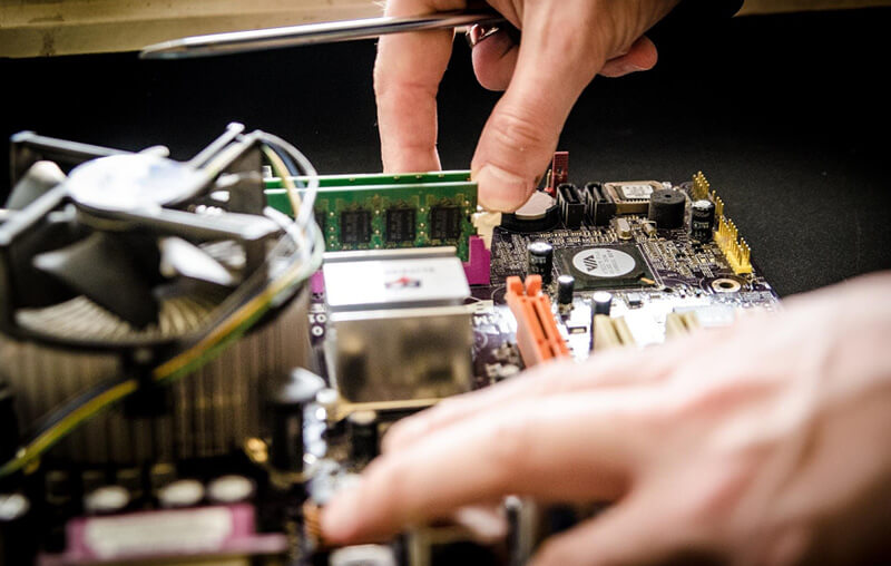 a computer technician with computer technician skills repairing device.