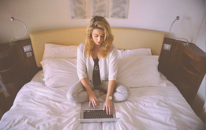 Woman taking online classes in the comfort of her own home.