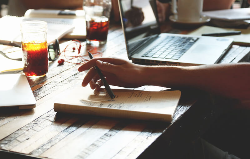 A student at the table with the ultimate study guide for students.