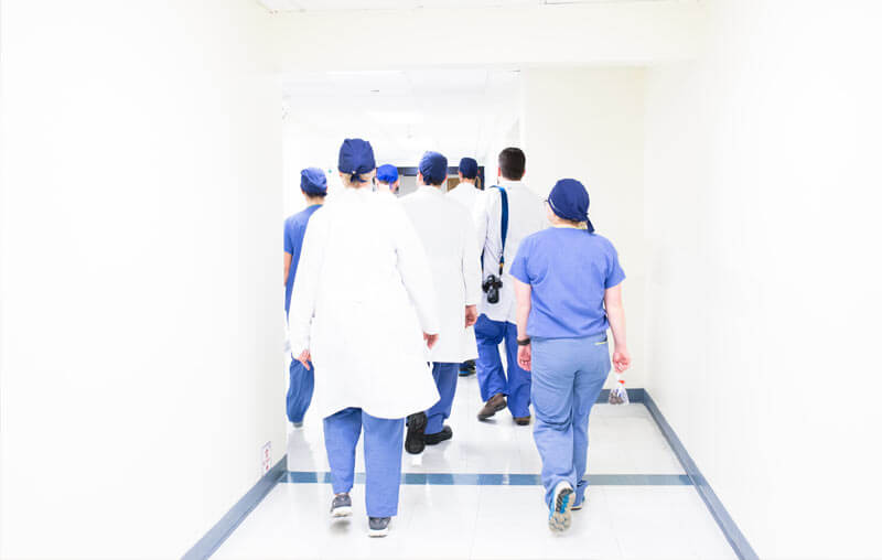 Medical assistants walking down a cooridor.