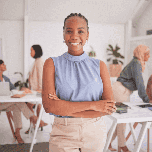 Image of female Business Management Degree holder smiling at camera in office