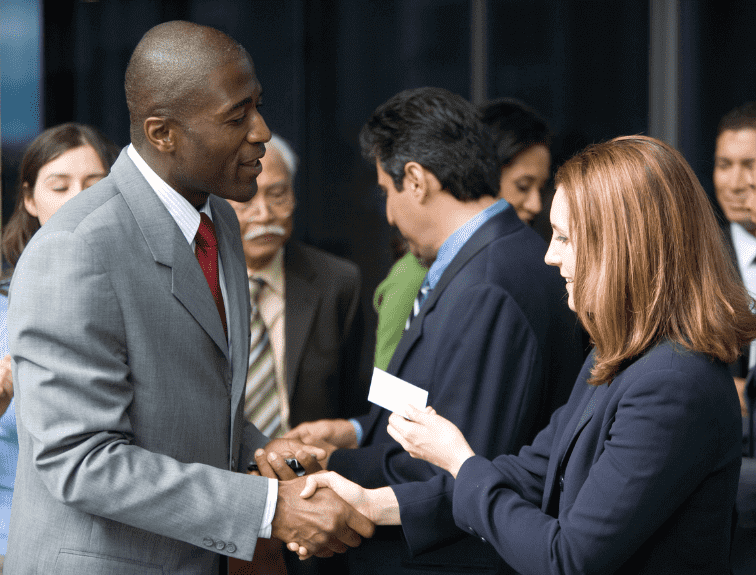Image of male and female engaging in professional networking at business event
